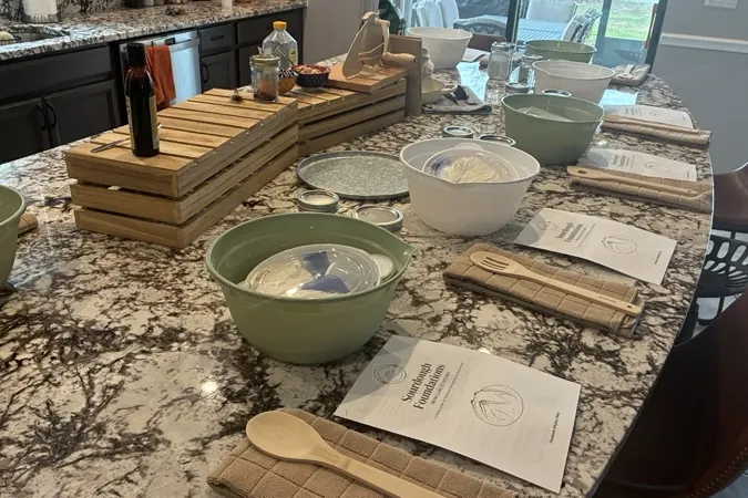 A small group of students at a class in a bright kitchen