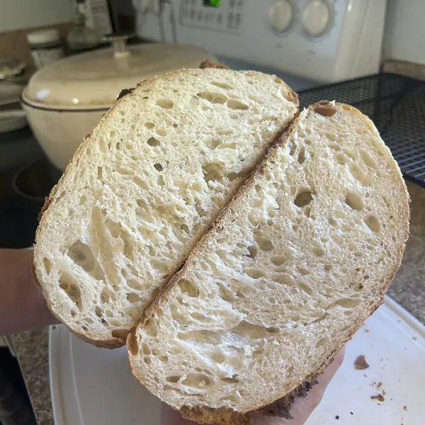 The open, airy crumb of a halved sourdough loaf