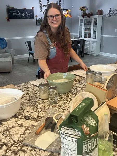 Rylee mixing dough at the kitchen island